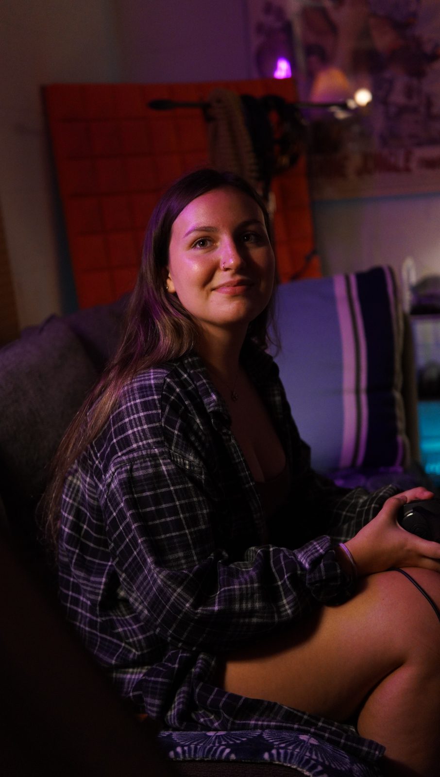 Bella seated in the studio, smiling toward the control desk